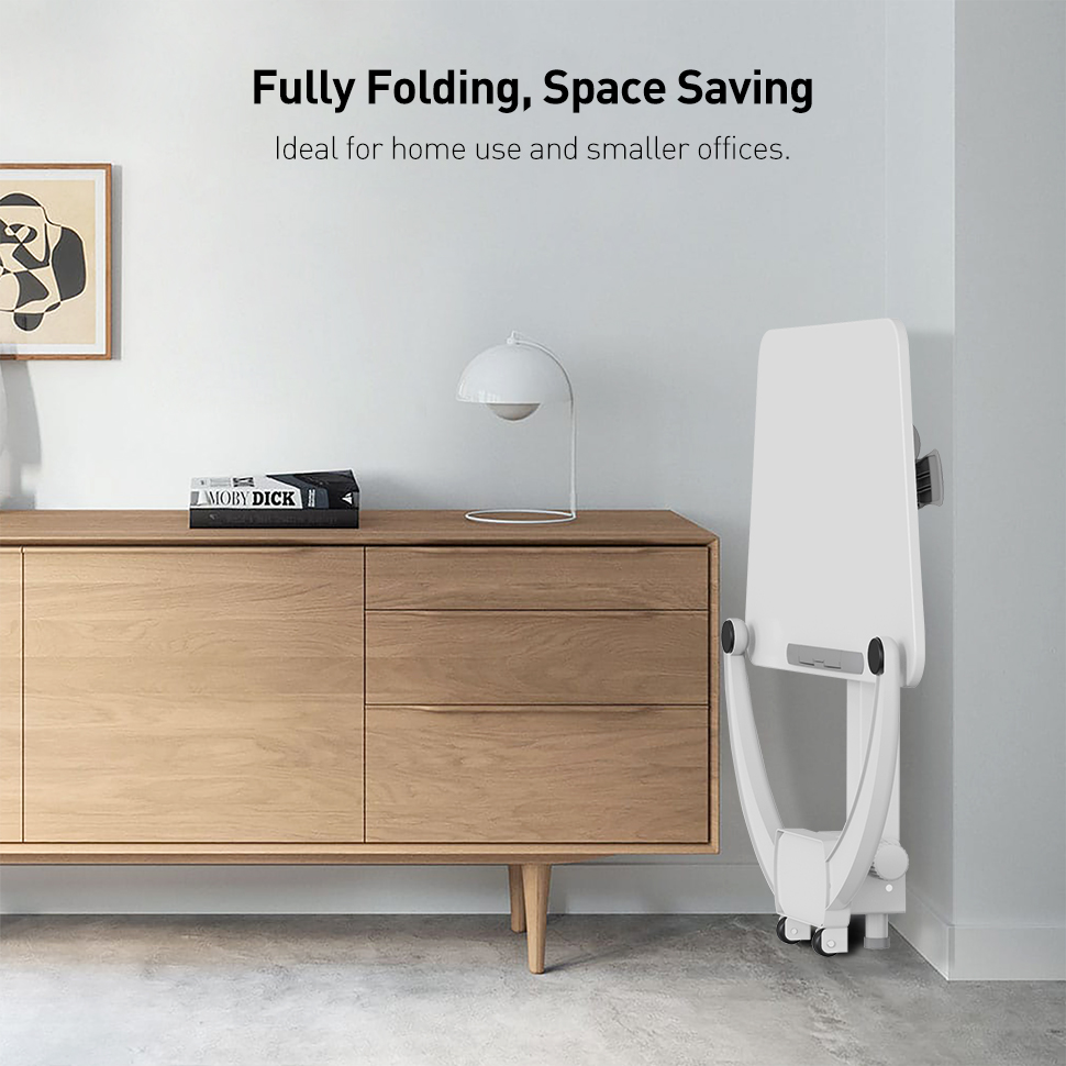 Fully folding portable standing desk stored upright against a wall next to a cabinet, designed to save space in small rooms