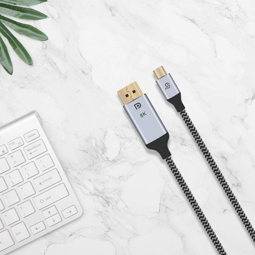 6ft nylon-braided USB-C to DisplayPort cable (marked 8K) is placed on the marble