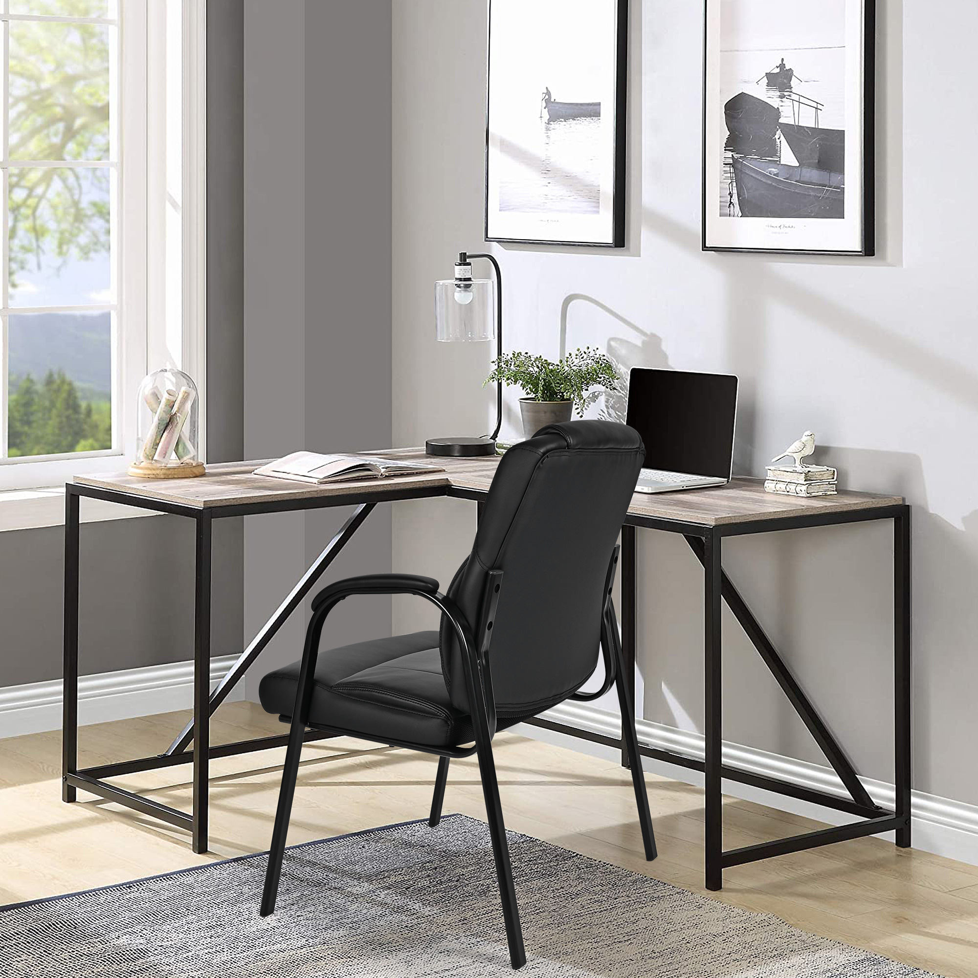 Moustache® black high back guest chair is placed beside at a L-shaped desk in the home office