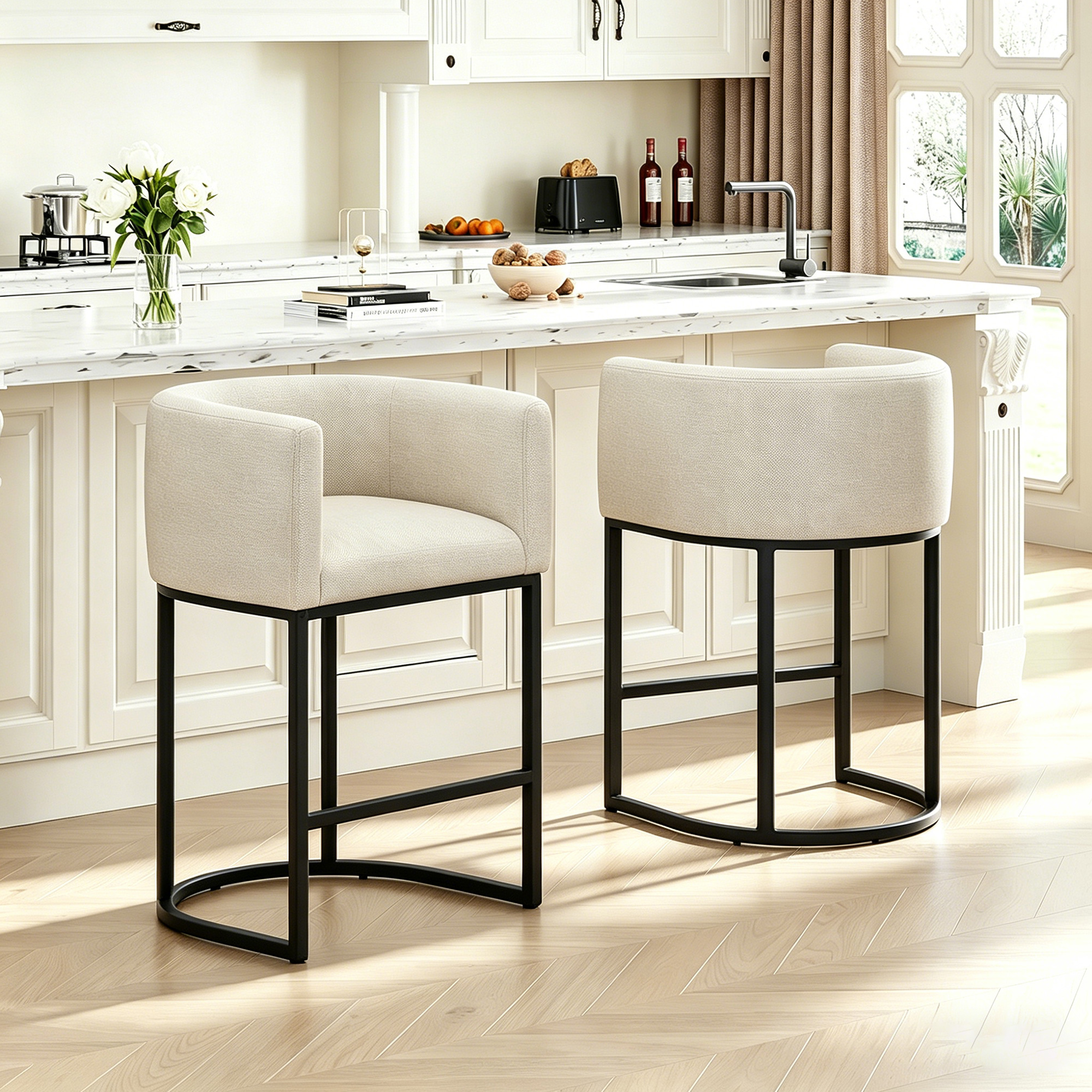 Two beige counter stools with black metal frames positioned side-by-side in a bright kitchen